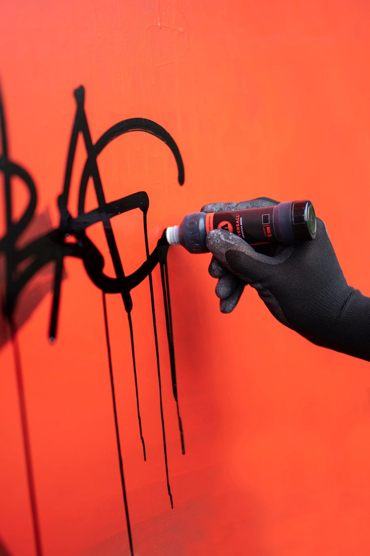 Black Squeezer on red wall